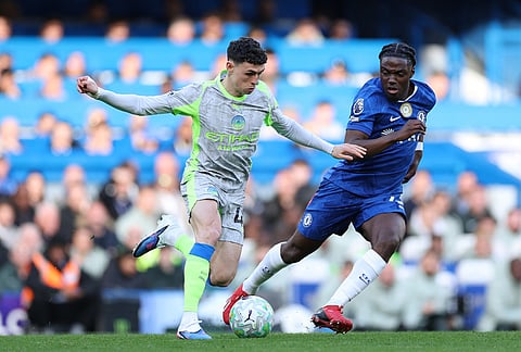 Manchester City's Phil Foden, left, and Chelsea's Romeo Lavia fight for the ball during the Premier League soccer match between Chelsea and Manchester City in London.