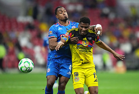 Cruz Azul's Willer Ditta, left, challenges America's Raul Zuniga during a Mexican soccer league match in Mexico City.