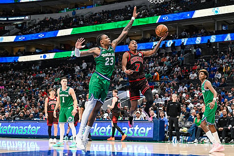 Chicago Bulls' Rob Dillingham drives past Dallas Mavericks' Tyler Smith during an NBA basketball game in Dallas.