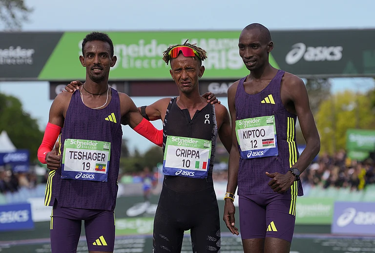 From left, Ethiopia's Bayelign Teshager, Italy's Yemaneberhan Crippa and Kenya's Sila Kiptoo pose after crossing the finish line of the men's race of the Paris marathon, in Paris. - | Photo: AP/Thibault Camus