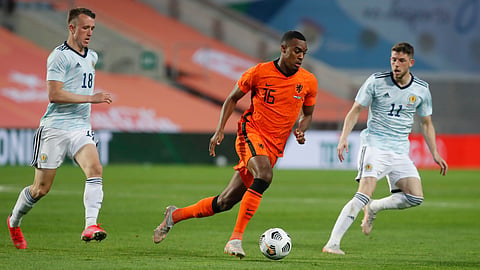 Netherlands' Ryan Gravenberch, center, runs with the ball during the international friendly soccer match between the Netherlands and Scotland at the Algarve stadium outside Faro, Portugal, Wednesday June 2, 2021.