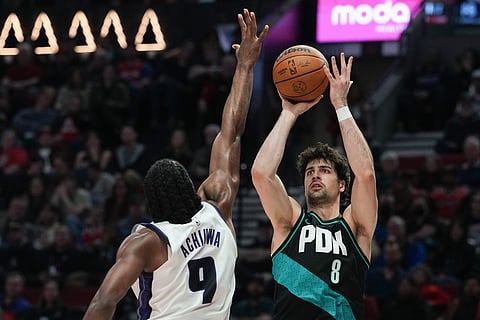 Portland Trail Blazers forward Deni Avdija (8) shoots past Sacramento Kings forward Precious Achiuwa (9) during the second half of an NBA basketball game in Portland, Ore.