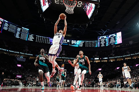 Sacramento Kings guard Nique Clifford (5) goes to the basket during the second half of an NBA basketball game against the Portland Trail Blazers in Portland, Ore.