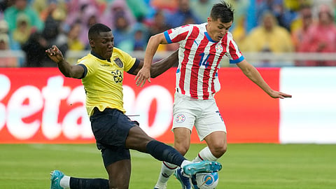 Ecuador's Moises Caicedo tackles Paraguay's Andres Cubas during a qualifying soccer match for the FIFA World Cup 2026 at Rodrigo Paz Delgado stadium in Quito, Ecuador, Thursday, Oct. 10, 2024. 