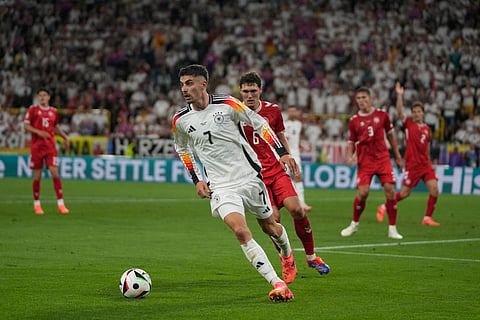 Germany's Nick Woltemade, left, celebrates after scoring the opening goal of his team during the World Cup 2026 group A qualifying soccer match between Northern Ireland and Germany at Windsor Park stadium, in Belfast, Northern Ireland, Monday, Oct. 13, 2025. 