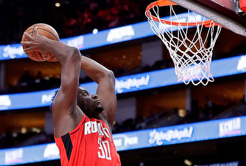 Houston Rockets center Clint Capela dunks against the Memphis Grizzlies during the second half of an NBA basketball game in Houston.