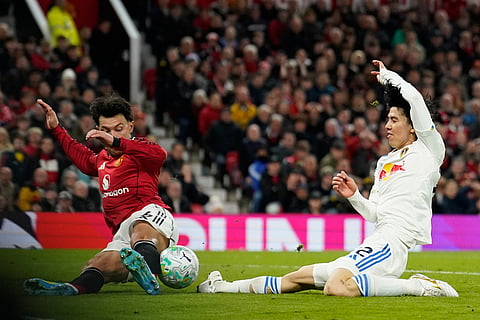 Manchester United's Ayden Heaven bloxks Leeds' Ao Tanaka during the Premiier League soccer match between Manchester United and Leeds in Manchester, England.