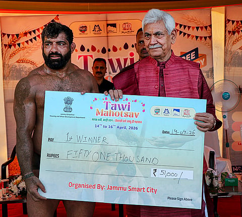 Jammu and Kashmir LG Manoj Sinha presents a cheque to a wrestler during the Tawi Mahotsav as part of the ‘Baisakhi’ festival celebrations, near Tawi riverfront in Jammu.