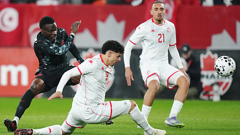 Canada's Tani Oluwaseyi, left, shoots as Tunisia's Alaa Ghram (18) and Moutaz Neffati (21) defend during the first half of an international friendly soccer match in Toronto, on Tuesday, March 31, 2026. 