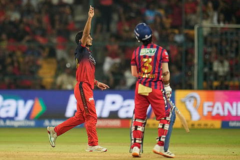 Royal Challengers Bengaluru's Rasikh Dar, left, celebrates the dismissal of Lucknow Super Giants' Ayush Badoni, right, during the Indian Premier League cricket match between Royal Challengers Bengaluru and Lucknow Super Giants in Bengaluru, India.