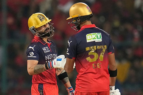 Royal Challengers Bengaluru's Virat Kohli, left, celebrates after hits a boundary with Devdutt Padikkal during the Indian Premier League cricket match between Royal Challengers Bengaluru and Lucknow Super Giants in Bengaluru, India.