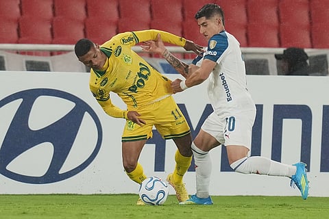 Negueba of Brazil's Mirassol, left, and Fernando Cornejo of Ecuador's Liga Deportiva Universitaria battle for the ball during a Copa Libertadores Group G soccer match in Quito, Ecuador.