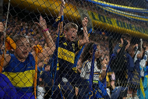 Fans of Argentina's Boca Juniors cheer during a Copa Libertadores Group D soccer match against Ecuador's Barcelona in Buenos Aires, Argentina.