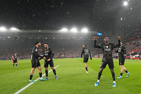 PSG's Ousmane Dembele, right, celebrates after scoring during the Champions League quarterfinal second leg soccer match between Liverpool and Paris Saint-Germain in Liverpool, England.