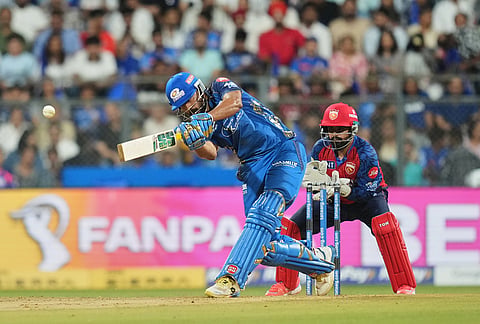 Mumbai Indians' Naman Dhir hits a six during the Indian Premier League cricket match between Mumbai Indians and Punjab Kings in Mumbai.