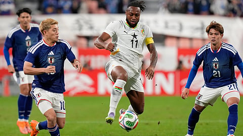Ghana's Antoine Semenyo, center, controls the ball against Japan's Ritsu Doan, left, during the international friendly soccer match between Japan and Ghana in Toyota, central Japan, Friday, Nov. 14, 2025.