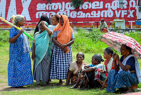 Women wait for food packets to be delivered amid scorching heat, in Thiruvananthapuram, Kerala. As the temperature rises sharply, the state government has urged people to stay out of direct sunlight and follow safety guidelines. 