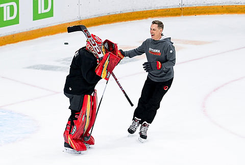 President of Finland Alexander Stubb reacts after scoring on net against Ottawa Charge goaltender Sanni Ahola (1) as he takes part in an Ottawa Charge practice with Canada's Prime Minister Mark Carney in Ottawa.