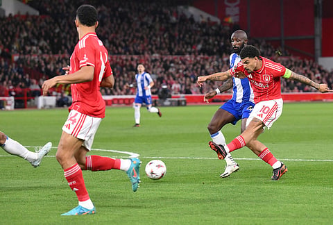 Nottingham Forest's Morgan Gibbs-White, right, scores during the Europa League quarterfinal second leg soccer match between Nottingham Forest and Porto in Nottingham, England.