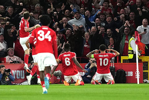 Nottingham Forest's Morgan Gibbs-White, right, celebrates scoring during the Europa League quarterfinal second leg soccer match between Nottingham Forest and Porto in Nottingham, England.