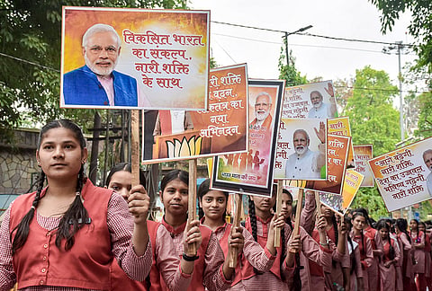 School students hold placards as they participate in the 'Nari Shakti Vandan Run', in Moradabad, Uttar Pradesh.