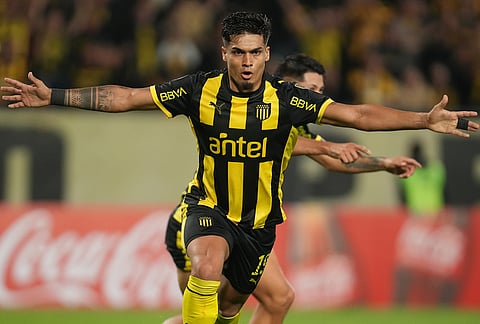 Douglas Arezo of Uruguay's Peñarol celebrates after scoring his side's first goal during a Copa Libertadores Group E soccer match against Argentina's Platense in Montevideo, Uruguay.