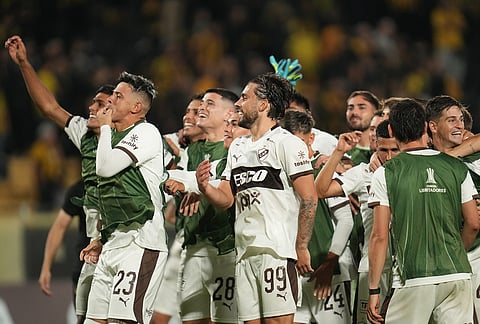 Players of Argentina's Platense celebrate beating Uruguay's Peñarol in a Copa Libertadores Group E soccer match in Montevideo, Uruguay.
