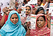 ‘Silent Purge’ Under SIR: Voter Roll Cuts Across Samserganj, Malda, Muslims Hit Hardest | Photo: Sandipan Chatterjee : The Missing Voters: Hasnara Khatoon (in blue), who lives in Harishchandrapur in Malda, says that despite having all the documents, five members of her family are missing from the list.
