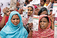 ‘Silent Purge’ Under SIR: Voter Roll Cuts Across Samserganj, Malda, Muslims Hit Hardest | Photo: Sandipan Chatterjee : The Missing Voters: Hasnara Khatoon (in blue), who lives in Harishchandrapur in Malda, says that despite having all the documents, five members of her family are missing from the list.
