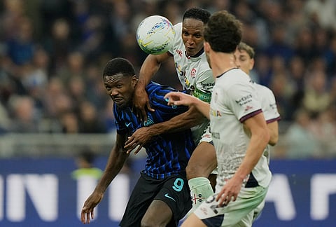 Inter Milan's Marcus Thuram, left, and Cagliari's Yerry Mina go for a header during the Serie A soccer match between Inter Milan and Cagliari in Milan, Italy.