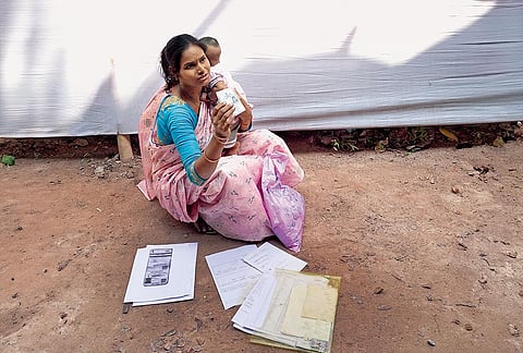 All Excluded: Pinky Khatoon Bibi travelled all the way from her village to the Malda Tribunal with her baby. She was seen sitting on the ground and struggling to fill scores of forms in a last-ditch effort