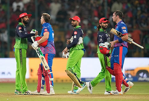 Delhi Capitals' Tristan Stubbs and David Miller shake hands with Royal Challengers Bengaluru's players after their win in the Indian Premier League cricket match between Royal Challengers Bengaluru and Delhi Capitals in Bengaluru.