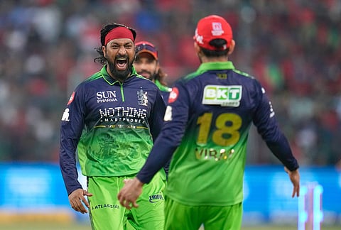 Royal Challengers Bengaluru's Krunal Pandya, left, celebrates the dismissal of Delhi Capitals' KL Rahul during the Indian Premier League cricket match between Royal Challengers Bengaluru and Delhi Capitals in Bengaluru.
