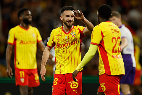 Lens' Adrien Thomasson celebrates after scoring during a League One soccer match between Lens and Toulouse in Lens, France.