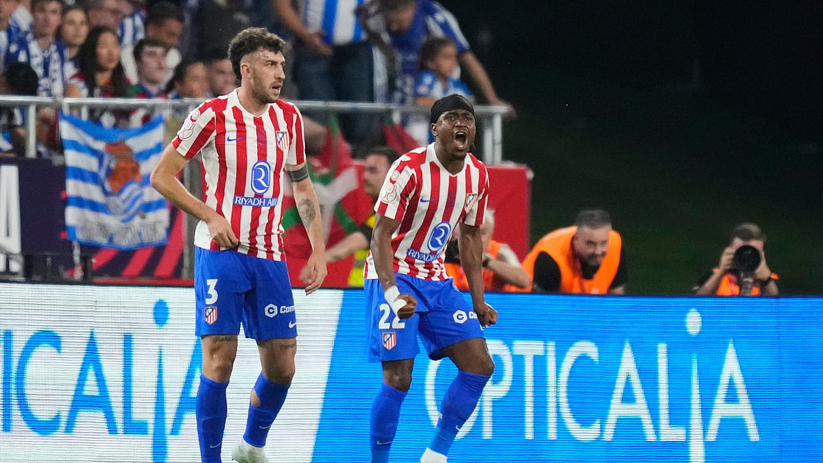 Atletico Madrid's Ademola Lookman, right, celebrates with Matteo Ruggeri after scoring his side's first goal during the Copa del Rey final soccer match between Atletico Madrid and Real Sociedad in Seville, Spain, Saturday, April. 18, 2026.

