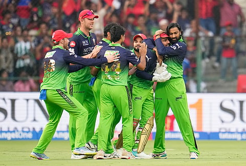 Royal Challengers Bengaluru's Phil Salt is congratulated by teammates for taking a catch to dismiss Delhi Capitals' Karun Nair during the Indian Premier League cricket match between Royal Challengers Bengaluru and Delhi Capitals in Bengaluru.