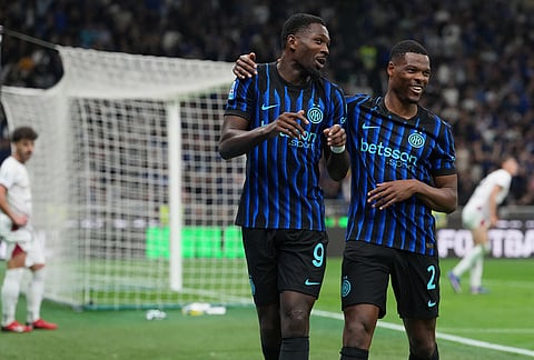 Inter Milan's Marcus Thuram, left, celebrates with his teammate Denzel Dumfries after scoring the opening goal during the Serie A soccer match between Inter Milan and Cagliari in Milan, Italy.