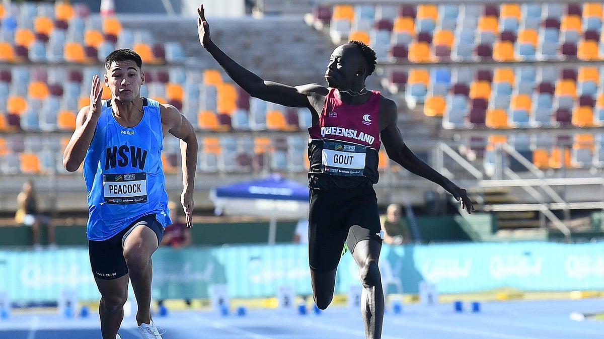 AP Photo : Gout Gout, right, waves while winning the junior 100-meter race at the Australian Athletics Junior Championship in Brisbane. 