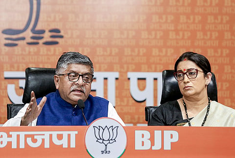 BJP leaders Ravi Shankar Prasad and Smriti Irani address a press conference, at party headquarters, in New Delhi.
