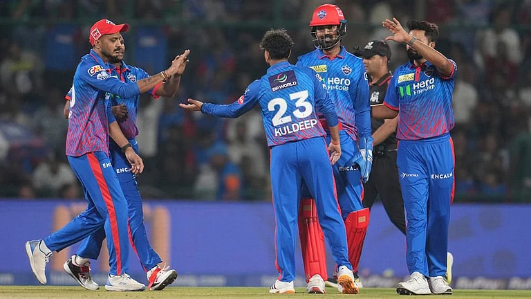 Delhi Capitals' Kuldeep Yadav, centre, celebrates with teammates the wicket of Gujarat Titans' Jos Buttler during the Indian Premier League cricket match between Delhi Capitals and Gujarat Titans in New Delhi. - | Photo: AP/Manish Swarup