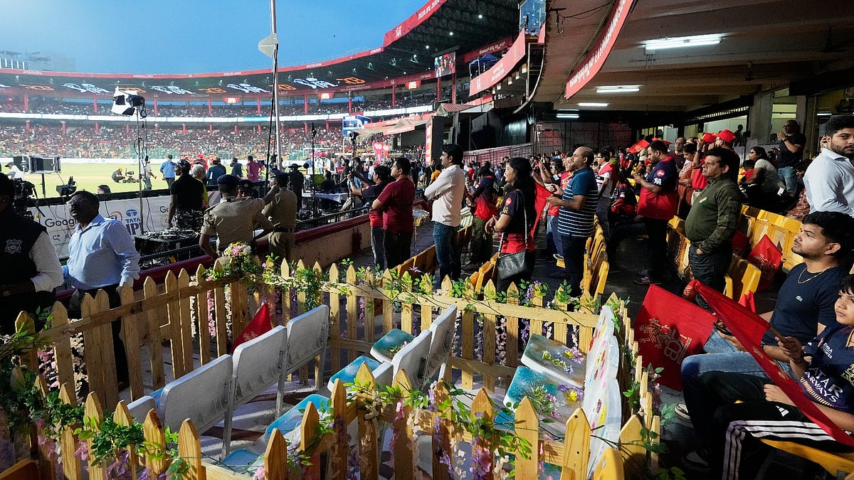 Eleven seats are kept at M Chinnaswamy Stadium as a tribute to 11 Royal Challengers Bengaluru fans who lost their lives in a stampede last year, as spectators wait for the Indian Premier League cricket match between Royal Challengers Bengaluru and Sunrisers Hyderabad to begin, in Bengaluru, India, Saturday, March 28, 2026.  - AP Photo/Aijaz Rahi)