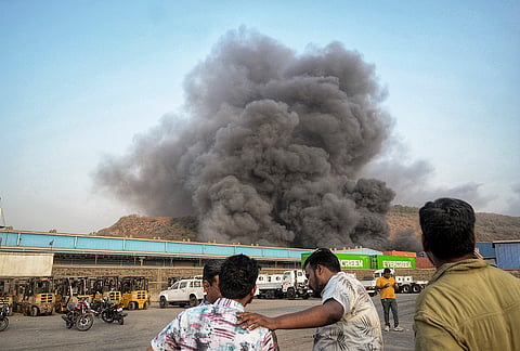 Thick plumes of smoke billow after a fire broke out at a warehouse, in Navi Mumbai district.