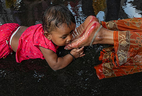 Devotees perform the Dondi ritual by lying prostrate along the road to reach a shrine on the occasion of Shitala Puja, in the Kalighat area, in Kolkata.