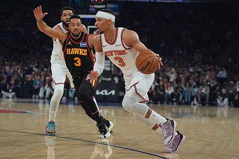 New York Knicks' Josh Hart (3) drives past Atlanta Hawks' CJ McCollum (3) during the first half in Game 1 of a first-round NBA playoffs basketball series in New York.