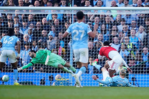 Manchester City's Erling Haaland scores his side's second goal during the English Premier League soccer match between Manchester City and and Arsenal, in Manchester, England.