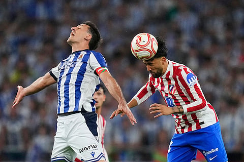 Atletico Madrid's Nico Gonzalez, right, and Real Sociedad's Mikel Oyarzabal challenge for the ball during the Copa del Rey final soccer match between Atletico Madrid and Real Sociedad in Seville, Spain.