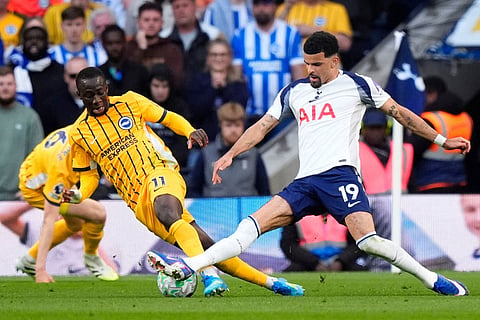 Brighton and Hove Albion's Yankuba Minteh, left, and Tottenham Hotspur's Dominic Solanke battle for the ball during their English Premier League soccer match in London.