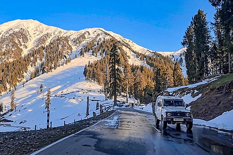Security personnel travel in a vehicle on the Bhaderwah-Chamba interstate road after it was reopened following over three months of closure due to snowfall, near Bhaderwah in Doda district, Jammu and Kashmir.
