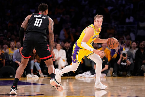 Los Angeles Lakers guard Luke Kennard, right, drives past Houston Rockets forward Jabari Smith Jr. during the second half in Game 1 of a first-round NBA playoffs basketball series in Los Angeles.