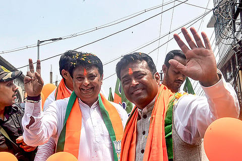 BJP leader Leander Paes, right, campaigns in support of party candidate from Dum Dum North constituency, Sourav Sikdar, ahead of the West Bengal Assembly elections, in Kolkata.